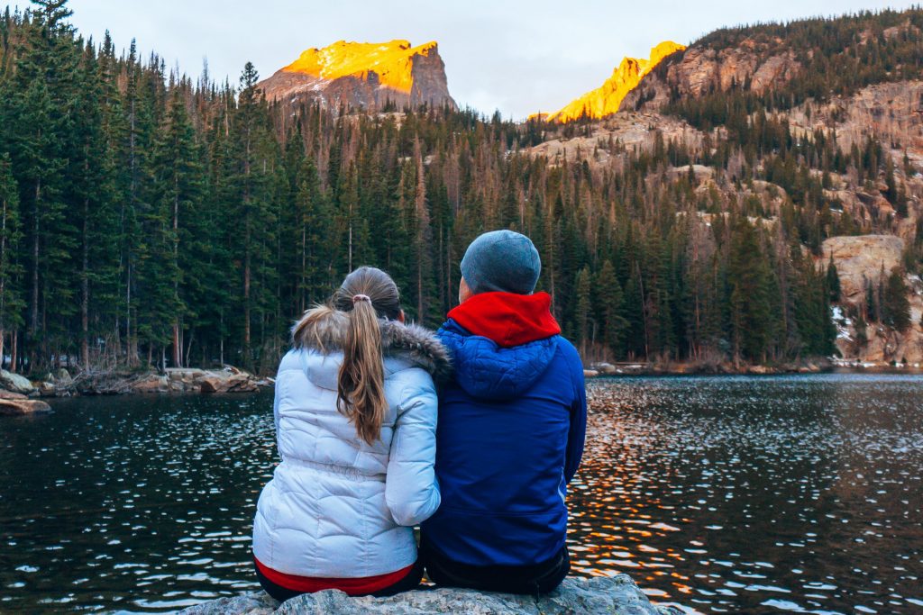 Sarah and Tim watch sunrise at Bear Lake in Rocky Mountain National Park