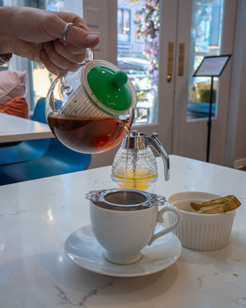 Pouring tea at Babe's Tea Room Denver